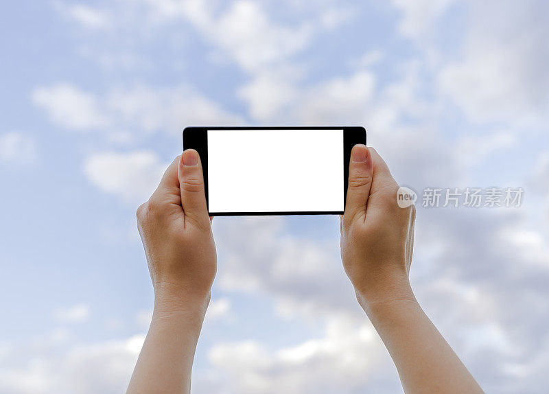 手持空白屏幕手机与海景和云蓝天背景
