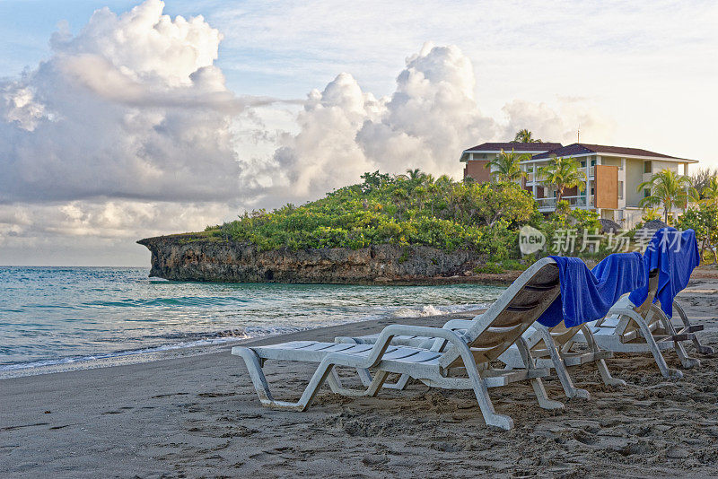 在美丽的热带海滩上的沙滩椅和雨伞