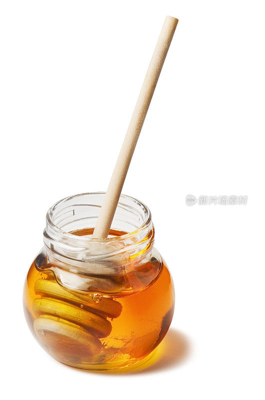 一罐纯金蜂蜜和一个木制的蜂蜜滴雨器