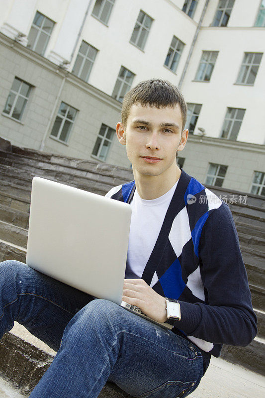 年轻的学生在用笔记本电脑工作