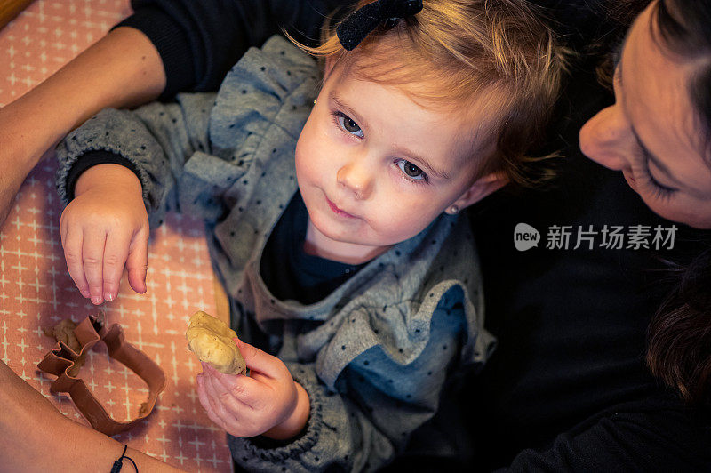 快乐的孩子女孩烤圣诞饼干库存照片