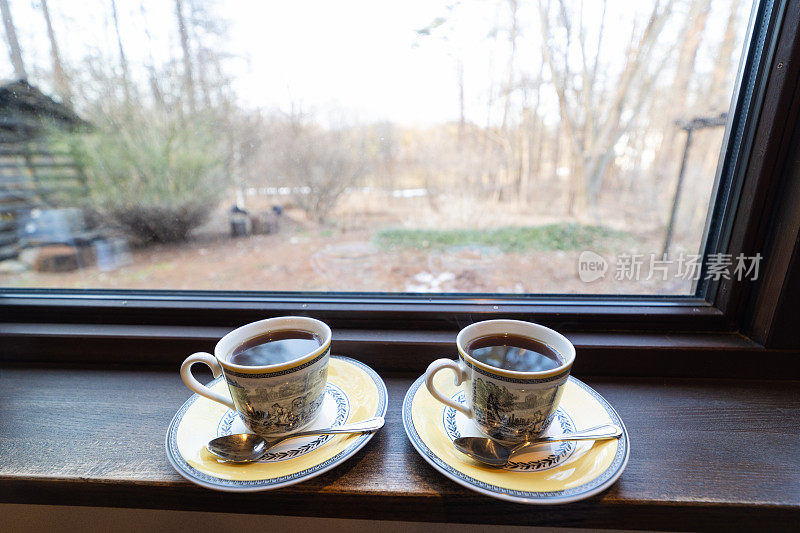 窗台上放着几杯新鲜的黑咖啡