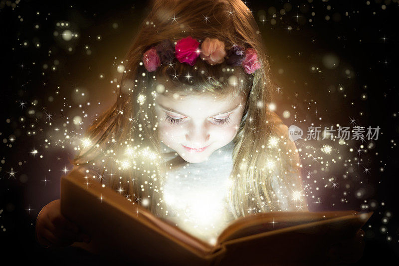 美丽的小女孩在读魔法书