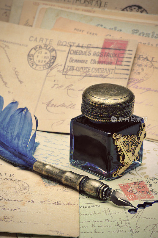 羽毛笔，墨水瓶和旧明信片。