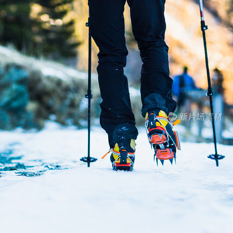 在结冰的小路上带冰爪的登山者