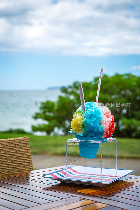 热带海滩桌上的夏威夷刨冰