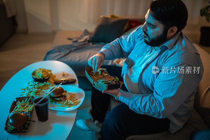 看电视吃垃圾食品的男人