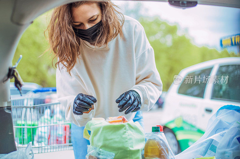 这是一个年轻女人的照片，她在车里装东西