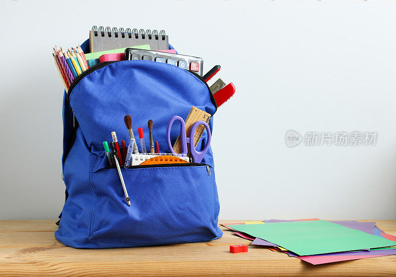 蓝色书包，里面有学习用品。