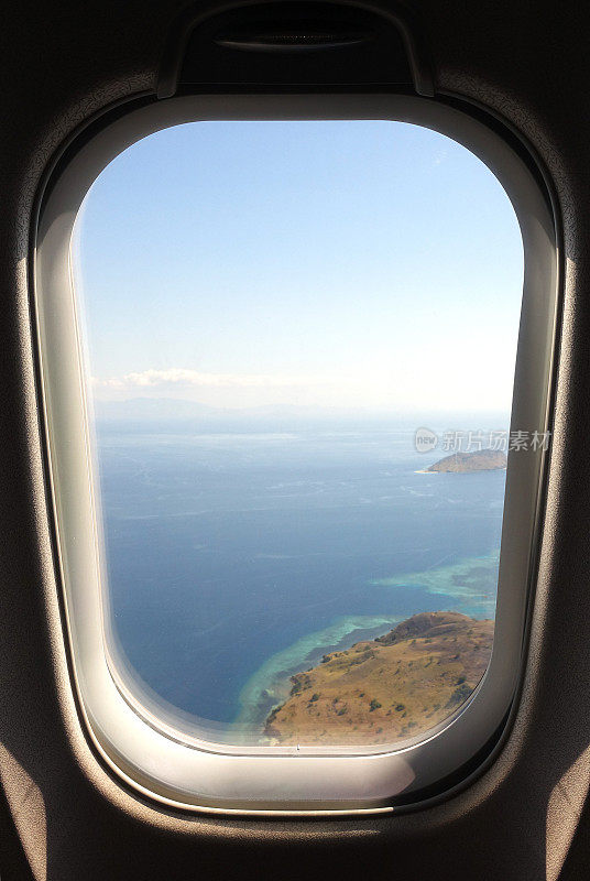 飞机窗口与异国情调的热带弗洛雷斯岛。
