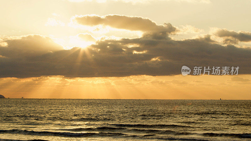 太阳在海上落下时的延时摄影。日落是橙色的，景色是极好的。这是一个神奇的时刻