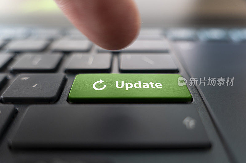 男子按下绿色按钮与文字更新现代黑色电脑键盘，特写