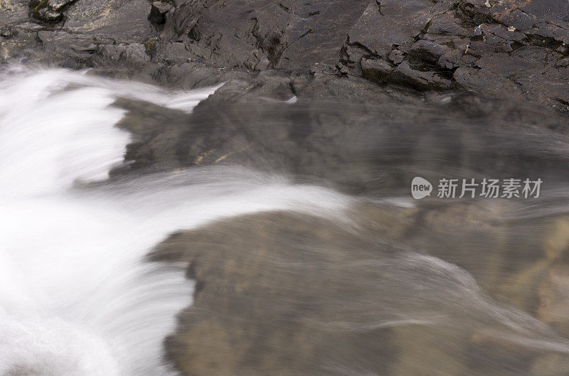 一股水流从山上的岩石上冲过