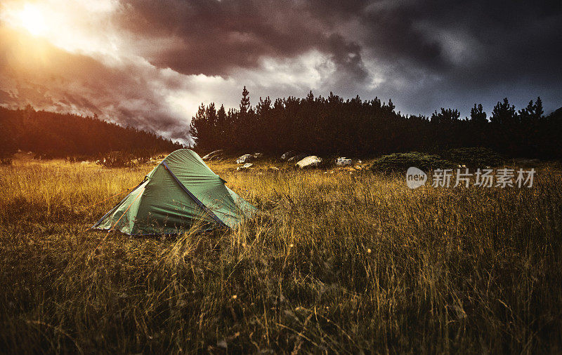 日落时分在山上露营在帐篷里