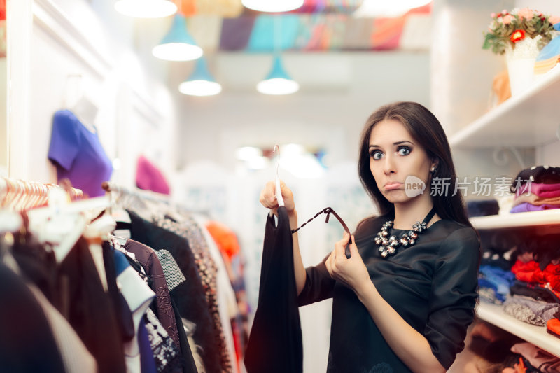 一名妇女正在查看服装店出售的价格标签