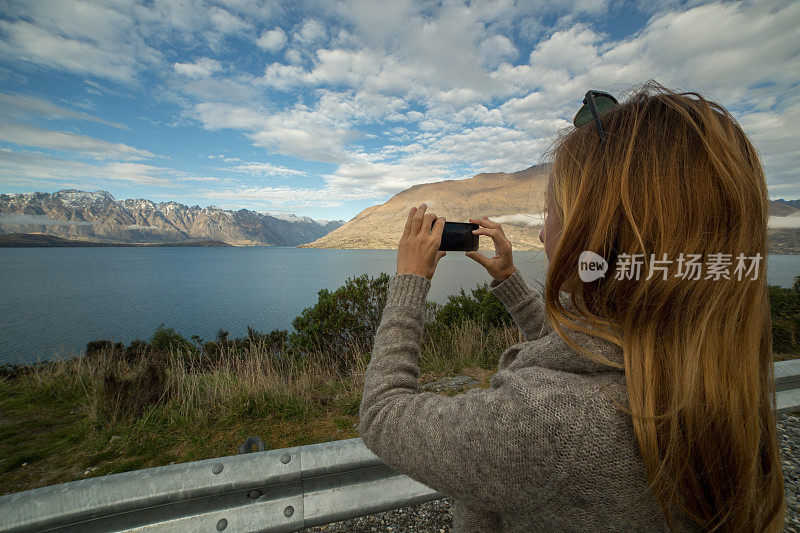 游客用手机拍摄风景