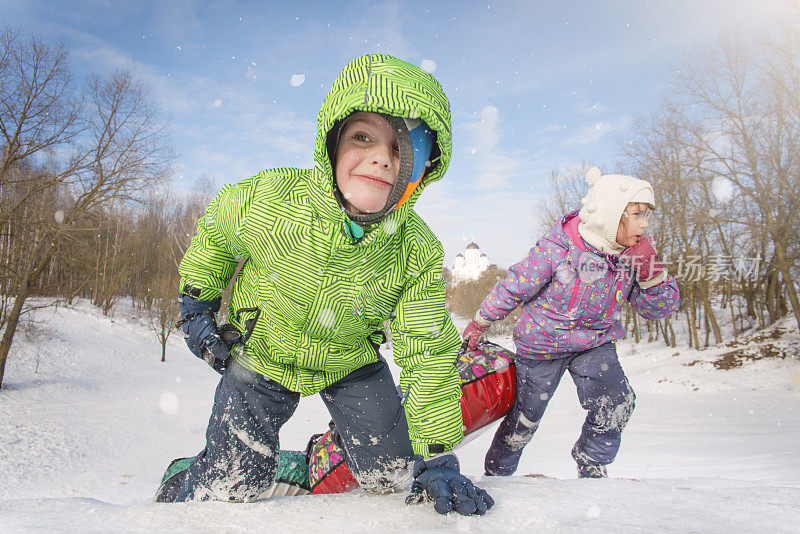 孩子们在山上玩雪橇。