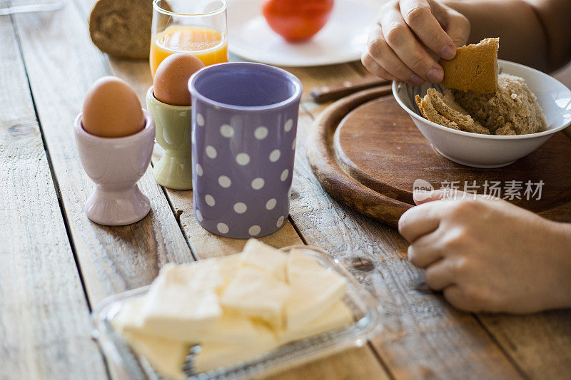 早餐在餐桌上-煮鸡蛋，摩泰台拉，软奶酪，酸奶和果汁