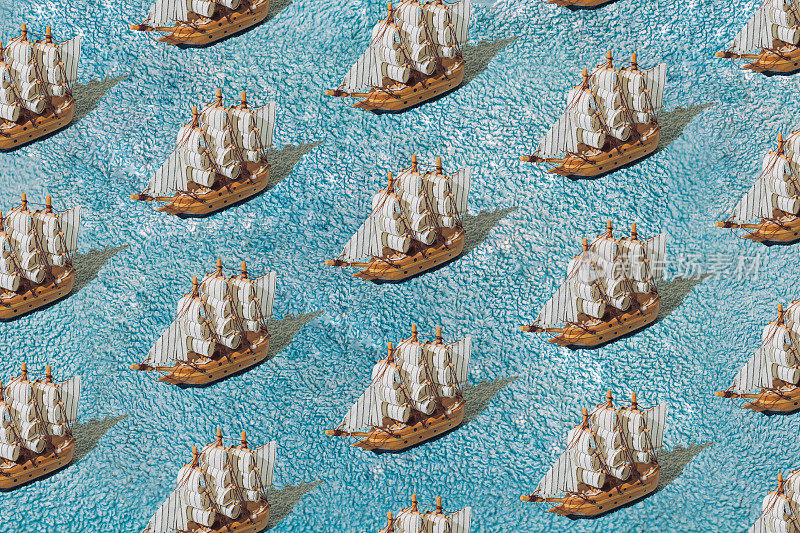 蓝色毛巾上的木制帆船。模式。