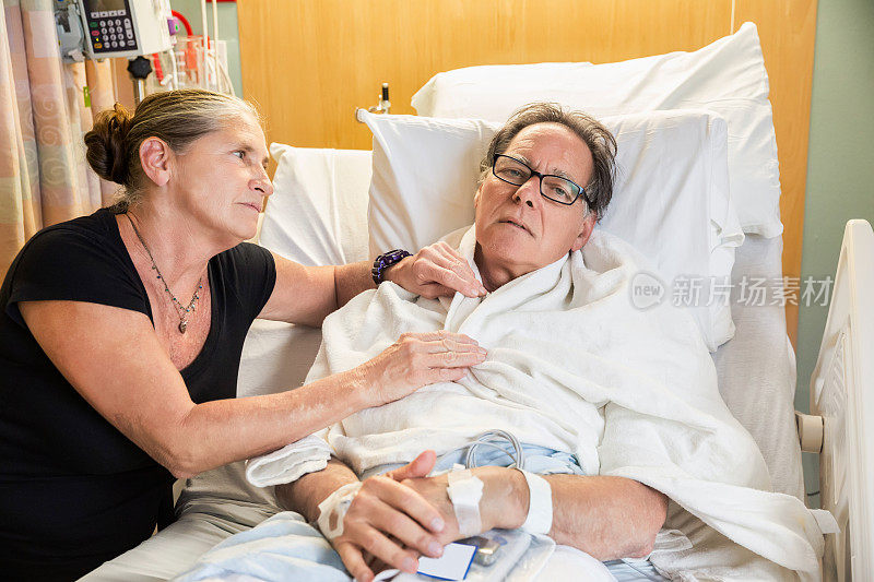 一位妇女在医院里安慰她生病的丈夫