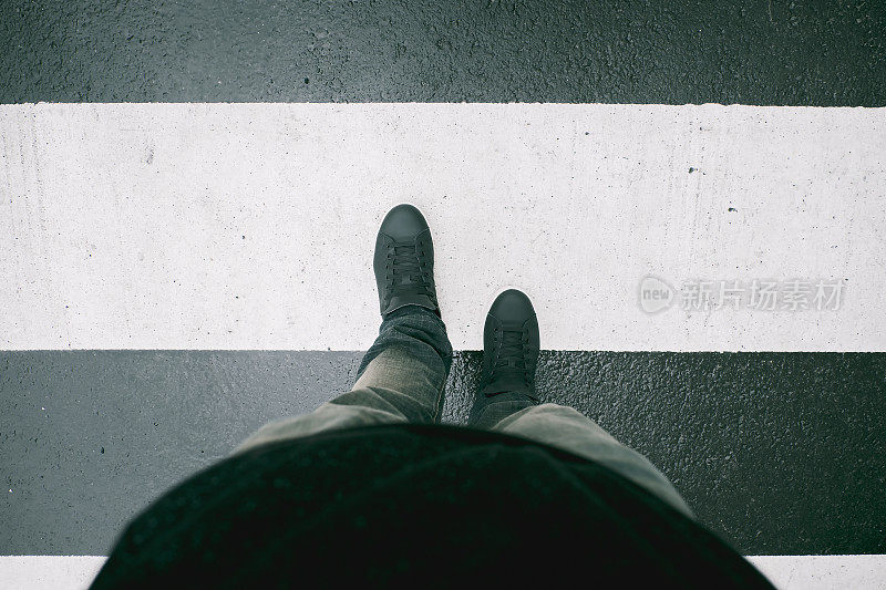 男人的脚在人行横道艺术滤镜上过马路