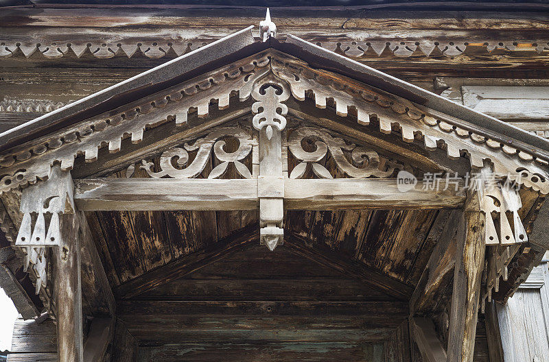前门上方古老的木质顶篷，带有装饰元素
