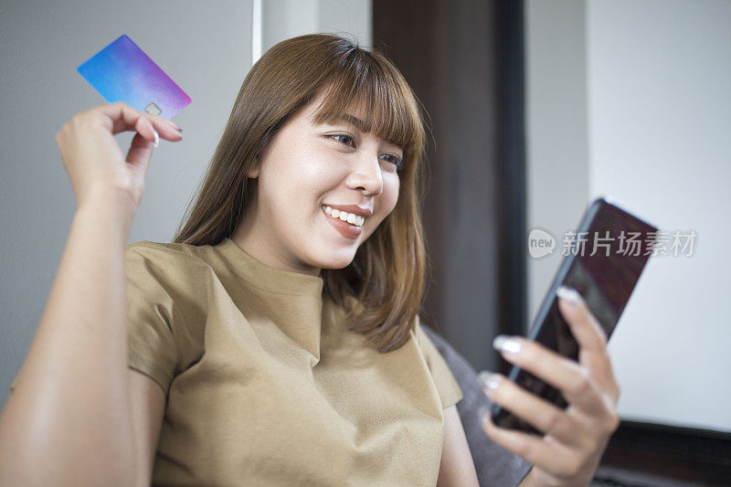 年轻美丽的亚洲女人在网上购物