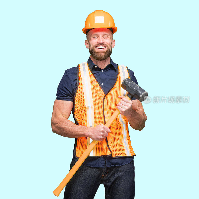 身穿马甲，手持大锤的白人建筑工人站在蓝色背景前