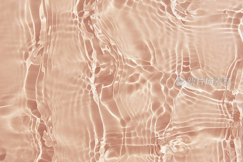 米色水纹理背景。抽象的图案
