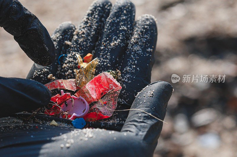 手捡起微塑料的特写镜头，显示它在手上