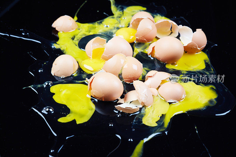许多鸡蛋被砸在黑色的背景上