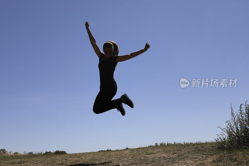 快乐和快乐，使跳跃的形状在蓝色的夏天的天空