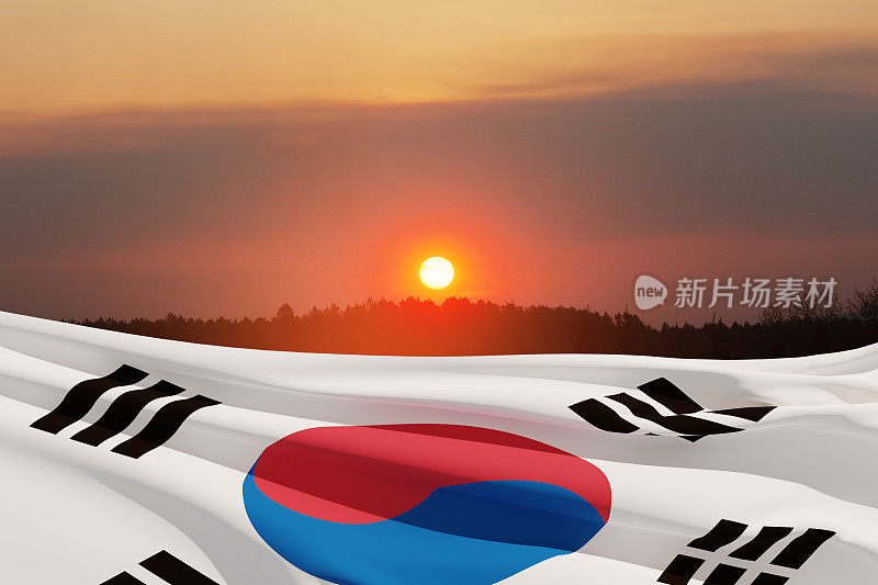在日落的天空挥舞着韩国国旗。