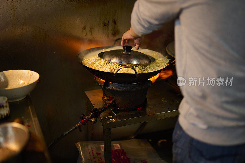 一位老师傅做了炒泥鳝面。台湾传统名品台湾街头小吃，台湾传统美食。近距离俯瞰中式美食，通常可以在夜市创办。台南,台湾。