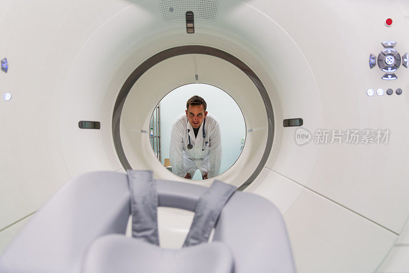 来自肿瘤研究所的场景…年轻医生站在PET扫描设备后面