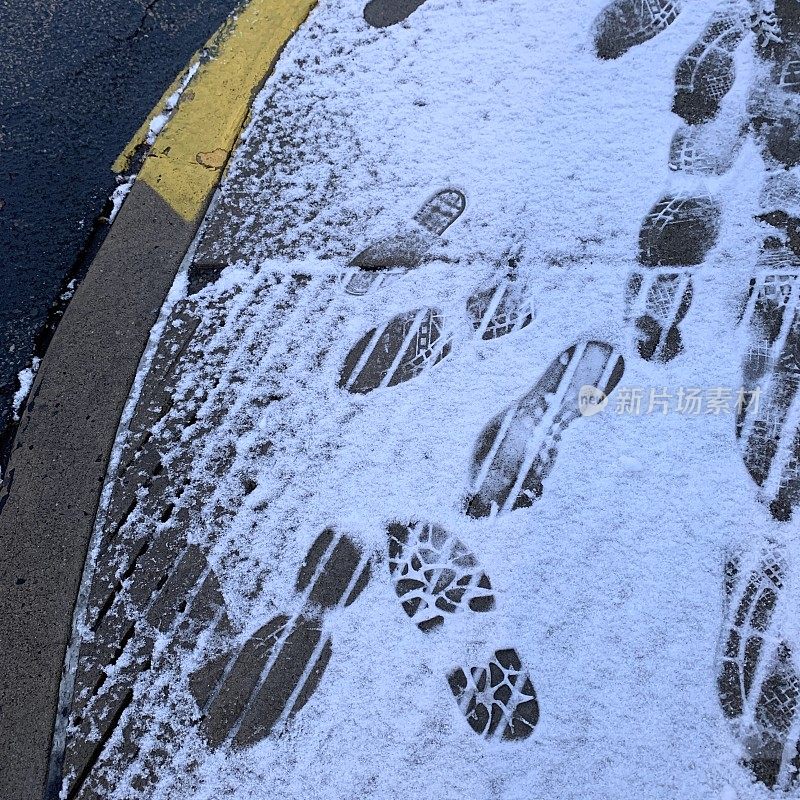 雪地人行道和防滑区的脚印