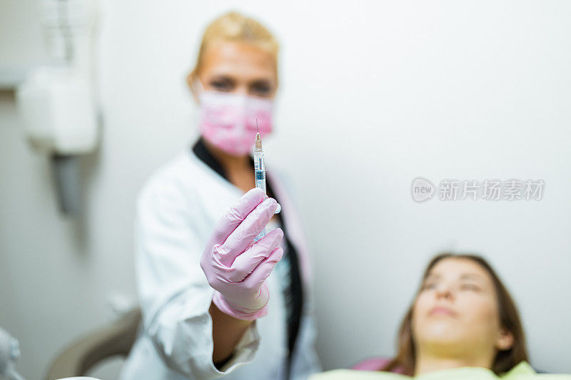年轻女子正在嘴唇上注射透明质酸