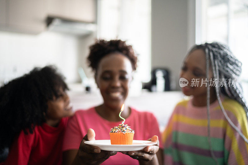 女儿们在家里用纸杯蛋糕庆祝妈妈的生日