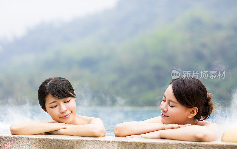快乐的年轻女子在温泉中放松