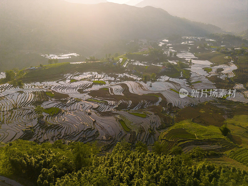 鸟瞰浇灌季节，越南老蔡省yty公社的梯田，棕色的土壤与美丽的天空融为一体。