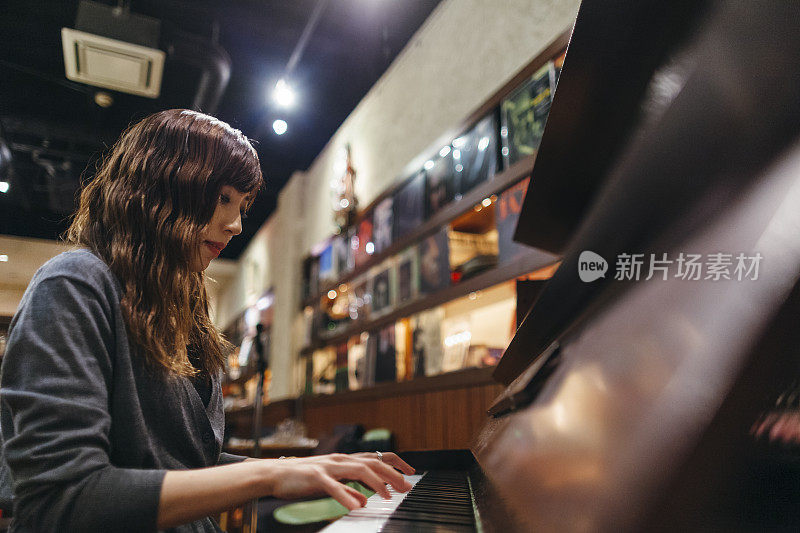 在爵士酒吧弹奏钢琴的女钢琴家