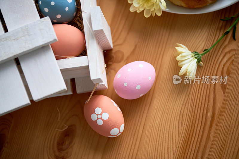 准备复活节庆祝活动:高角度观看美丽的彩色彩蛋在木桌上