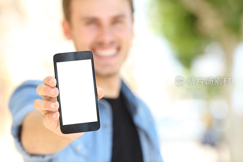 一名男子在街上显示一个空白的手机屏幕