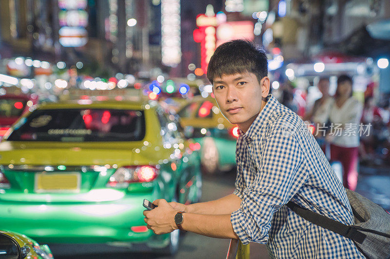 年轻的亚洲男人喜欢在泰国曼谷的中国城Yaowarat街旅游