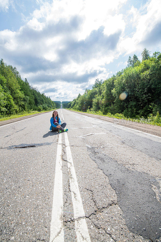 坐在乌拉尔山脉路上的年轻女子，佩尔姆，俄罗斯
