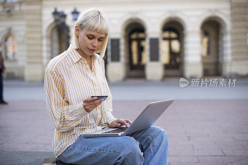 一位女士用她的信用卡在网上购买库存照片