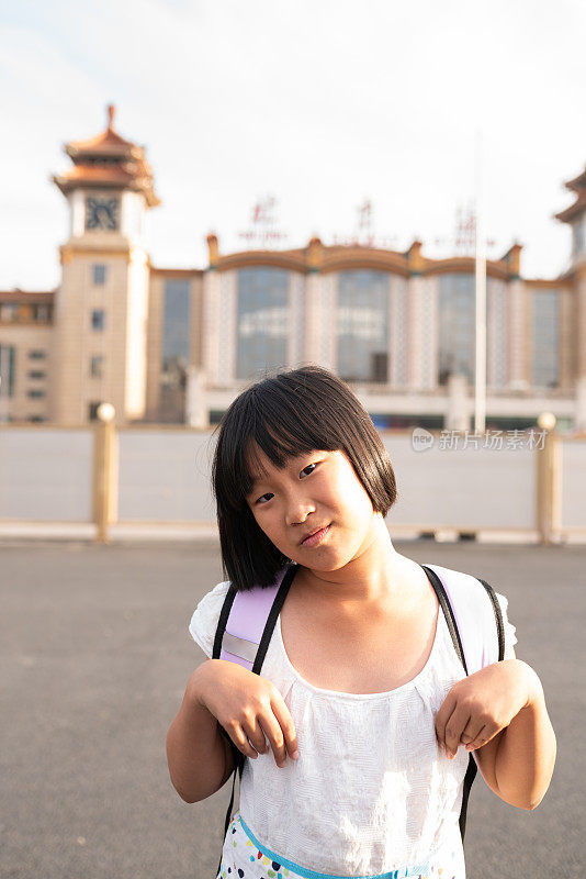 亚洲小学女孩在北京火车站前旅行