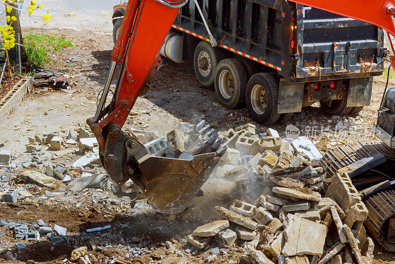 挖掘机将建筑废料装入建筑废料中进行处置