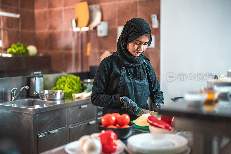 穿制服的女厨师工作时腰部以上的照片