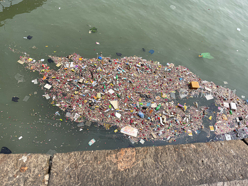 垃圾漂浮在印度门户滨水区被污染的海面上的特写图像，水污染，垃圾，垃圾和废物窒息流动的水，高架视图